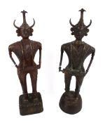 A pair of Indian West Bengal cast metal figures. In a standing position holding instruments, H41cm.