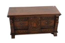 A 20th century carved oak coffer.