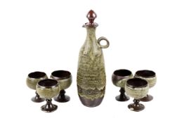 Glynn Hugo studio art pottery decanter and six matching goblets. Stamped 'Hugo' to the base. Max.