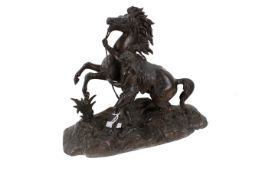 A cast metal horse and rider. In black, H26cm.