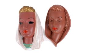 Two mid-century Goldscheider West German ceramic wall masks. Modelled as women with head scarves.