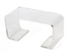 A contemporary curved Perspex coffee table.