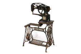 A vintage industrial Singer leather stitching sewing machine and stand.