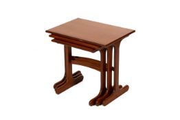 A mid-century nest of three teak tables. Max.