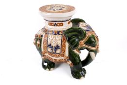 A ceramic elephant garden seat. Glazed green with white seat, H39cm.