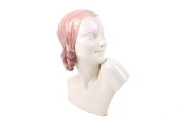 An Art Deco ceramic bust of a young woman.
