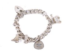 A silver charm bracelet with three charms.