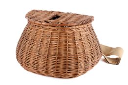 A vintage wicker fishing creel. Of semicircular shape with leather straps and canvas sling, H23cm.
