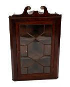 A mahogany astral glazed corner cabinet. With swan neck pediment with brass finial.