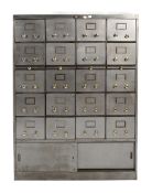 A mid-century industrial bank of drawers. Twenty drawers above a cupboard with sliding doors.
