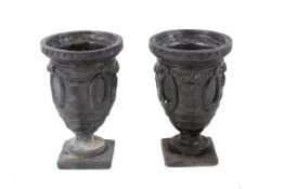Pair of small cast lead classical style urns.
