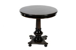 A contemporary ebonised centre table. Top over a central column on four ball feet. H 81cm Dia 81cm.