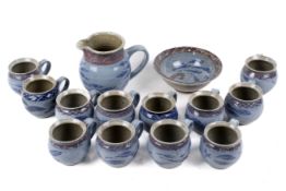 A Studio Art Pottery set of twelve mugs, a jug and a dish. With fish and octopus design. Max.