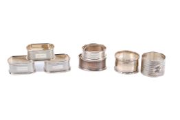 A collection of seven silver napkin rings.