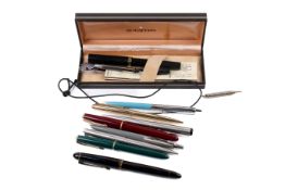 Collection of fountain and ballpoint pens.