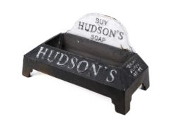 A cast metal 'Hudson's Soap' dog's drinking trough, painted black.