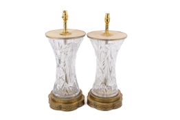 Pair of contemporary cut glass and brass table lamps. Raised on pierced stepped brass bases.