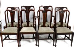 A set of eight Art Nouveau carved mahogany dining chairs.