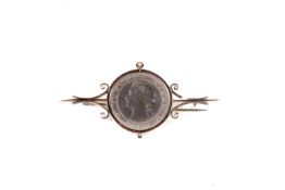 An 1887 Jamaica half penny set in gold mount. The mount marked 9ct.