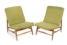 A pair of Ercol 'loungers' beech chairs model 427. With green fabric cushions.
