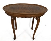 A walnut quarter veneered oval side table. On cabriole legs, H67cm.