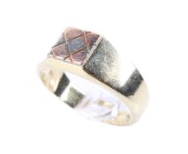 A vintage 14ct gold ring. With two-colour patchwork to the flat head, stamped 585, size X, weight 7.