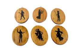 Set of six silhouettes of ebony inlaid classical figures. Of oval form.
