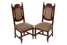 A pair of carved mahogany framed upholstered chairs.