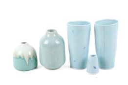 Group of five pale blue/turquoise studio and other pottery vases. Three signed 'Taja', Max.