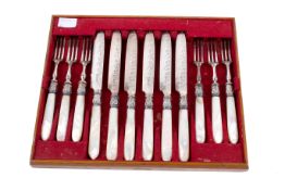A set of six silver and mother-of-pearl handled knives and forks.