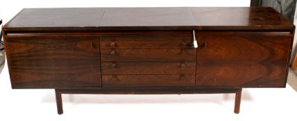 A mid-century sideboard with hot plate.