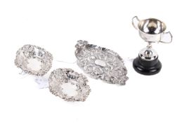 Four silver table items.