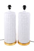 Pair of white ceramic bamboo effect table lamps. Raised on a gilt metal base.