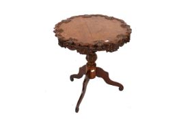 A Victorian oak carved tripod table.