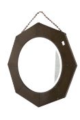 An Arts and Crafts style planished octagonal copper frame wall mirror.