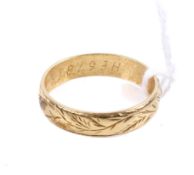 An 18ct gold wedding band. Engraved with a continuous band of branches, size R/S, weight3.9g.