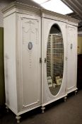 A large painted triple wardrobe.