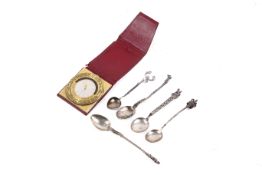 A vintage Hermes brass travel clock and five silver and white metal spoons. The clock marked o.