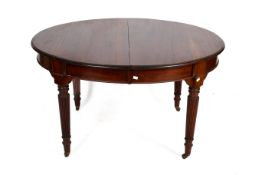 A mahogany oval extending table.