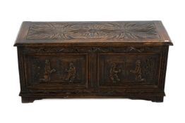 A carved oak blanket box. Carved detail to the top and front, hinged lid, on block feet.