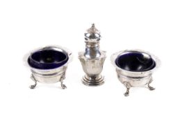 Two silver condiment pots and a pepper pot.