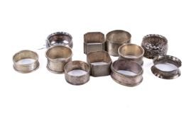 A group of eleven silver and white metal napkin rings.