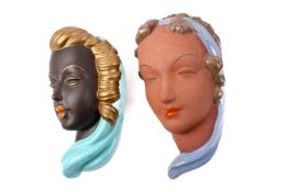 Two assorted mid-century ceramic wall masks.