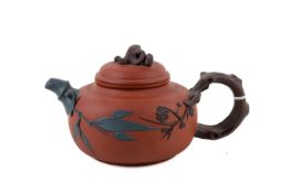A 20th century Chinese Yixing terracotta tea pot and cover.