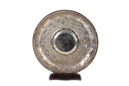 Indian white metal plate embossed with various animals. Diameter 30.5cm, 418g. With wooden stand.