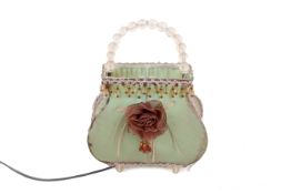 Vintage table lamp in the form of a 'handbag'. Fabric covered with a fabric rose to front.