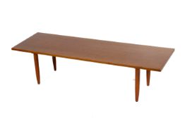 A mid-century rectangular teak coffee table. Raised on square tapering supports.