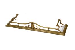 A late 19th / early 20th century brass fire fender.