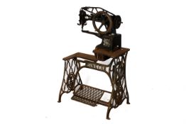 A vintage industrial Singer leather stitching sewing machine and stand.
