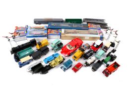 An assortment of diecast and OO gauge freight stock.